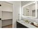 Elegant bathroom with a lit mirror, modern vanity, and walk-in closet at 44035 Pony Express Ct, Elizabeth, CO 80107
