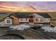 Stunning aerial view of a two-story home with a large yard at sunset at 44035 Pony Express Ct, Elizabeth, CO 80107