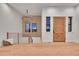 Bright and airy entryway with hardwood floors, chandelier, and wooden wall accents at 44035 Pony Express Ct, Elizabeth, CO 80107