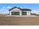 Two-car garage with neutral siding and landscaping at 44035 Pony Express Ct, Elizabeth, CO 80107