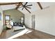 Main bedroom with vaulted ceiling, wood beams, and a view of the backyard at 44035 Pony Express Ct, Elizabeth, CO 80107