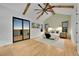 Spacious main bedroom with wood-beamed ceiling, large windows, and sliding glass doors to deck at 44035 Pony Express Ct, Elizabeth, CO 80107
