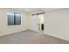 Spacious basement bedroom with grey carpet, large window, and sliding barn door at 44035 Pony Express Ct, Elizabeth, CO 80107