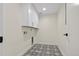 Bright laundry room with white cabinets, patterned floor, and built-in shelving at 44035 Pony Express Ct, Elizabeth, CO 80107