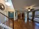 Open-concept living room with hardwood floors, fireplace, and large windows at 6309 S Newbern Way, Aurora, CO 80016