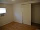 Simple bedroom featuring wood floors and a closet at 765 S Krameria St, Denver, CO 80224