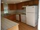 Kitchen with wood cabinets, tile counters, and appliances at 765 S Krameria St, Denver, CO 80224