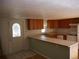 Small kitchen with wood cabinets, tile countertops, and a breakfast bar at 765 S Krameria St, Denver, CO 80224