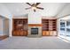 Living room with a fireplace and built-in shelving units at 24940 E Roxbury Pl, Aurora, CO 80016