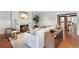 Elegant living room with fireplace, hardwood floors, and access to the kitchen at 110 N Franklin St, Denver, CO 80218