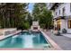 Luxury pool with a waterfall feature and adjacent patio with fireplace at 110 N Franklin St, Denver, CO 80218