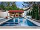 Inviting pool with spa and waterfall feature; covered patio with fireplace nearby at 110 N Franklin St, Denver, CO 80218