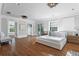 Spacious primary bedroom with hardwood floors and access to a private balcony at 110 N Franklin St, Denver, CO 80218
