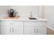 Compact wet bar with sink and cabinets at 3450 N Downing St # 3, Denver, CO 80205