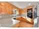 Galley kitchen with light wood cabinets, speckled countertops, and stainless steel appliances at 1080 Marigold Dr, Denver, CO 80221