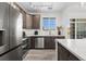 Modern kitchen with stainless steel appliances and an island at 18633 Stroh Rd # 1-102, Parker, CO 80134