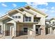 Two-story townhome with light-beige exterior and stone accents at 18633 Stroh Rd # 1-102, Parker, CO 80134