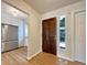 Light and airy entryway with hardwood floors and kitchen view at 7264 Siena Way # C, Boulder, CO 80301