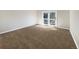 Bright bedroom with gray carpet and access to balcony at 7264 Siena Way # C, Boulder, CO 80301