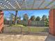 Backyard patio with brick columns, pergola, and gate at 7264 Siena Way # C, Boulder, CO 80301