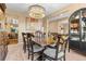 Elegant dining room with a large table, chandelier, and built-in hutch at 23450 Bent Oaks Way, Parker, CO 80138