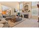 Spacious living room featuring a cozy fireplace and large windows at 23450 Bent Oaks Way, Parker, CO 80138