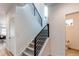 Modern staircase with sleek metal railing and carpet treads at 6043 N Nepal St, Aurora, CO 80019
