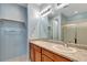 Double vanity bathroom with shower and linen shelf at 27646 E 10Th Dr, Aurora, CO 80018