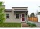Charming stucco home with red door and steps leading to the entrance at 2660 Utica St, Denver, CO 80212