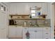 White kitchen with granite countertops and subway tile backsplash at 2660 Utica St, Denver, CO 80212