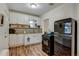 White kitchen cabinets, granite countertops, and black appliances at 2660 Utica St, Denver, CO 80212