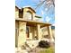 Two-story house with tan siding, a covered porch, and a well-maintained front yard at 12578 Dexter Way, Thornton, CO 80241