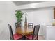 Small dining area with round table and four chairs at 381 S Ames St # B103, Lakewood, CO 80226