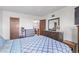 Bedroom with a dresser, full bed, and access to another room at 381 S Ames St # B103, Lakewood, CO 80226
