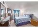 Well-lit bedroom with full bed, dresser and nightstand at 381 S Ames St # B103, Lakewood, CO 80226