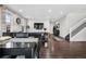 Bright dining area features dark hardwood floors and a modern glass table at 2053 S Cathay Way, Aurora, CO 80013