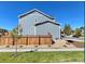 Two-story house with gray siding and a wooden fence at 2053 S Cathay Way, Aurora, CO 80013