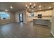 Open living area with laminate flooring and lots of natural light at 2778 Optimista Pl, Brighton, CO 80601