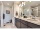 Double vanity bathroom with a large mirror and walk-in shower at 6621 N Ceylon St, Denver, CO 80249