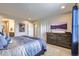 Main bedroom with dresser, large windows and en-suite bathroom at 6621 N Ceylon St, Denver, CO 80249