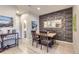 Charming dining area with a rustic table, four chairs, and a textured wall at 6621 N Ceylon St, Denver, CO 80249