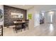 Cozy dining area with a dark wood table, four chairs, and a textured wall at 6621 N Ceylon St, Denver, CO 80249