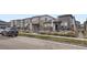 Modern townhome with landscaped front yard and walkway at 6621 N Ceylon St, Denver, CO 80249
