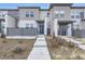 Modern two-story townhome with gray and white siding, and a landscaped front yard at 6621 N Ceylon St, Denver, CO 80249
