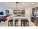 Modern kitchen with island, stainless steel appliances, and white quartz countertops at 6621 N Ceylon St, Denver, CO 80249