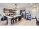 Modern kitchen with dark wood cabinets, stainless steel appliances, and an island with seating at 6621 N Ceylon St, Denver, CO 80249