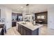 Modern kitchen with island, stainless steel appliances, and white quartz countertops at 6621 N Ceylon St, Denver, CO 80249