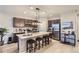 Modern kitchen with dark cabinets, stainless steel appliances and a large island with seating at 6621 N Ceylon St, Denver, CO 80249