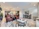 Open-concept living space with hardwood floors, comfortable seating, and views into the kitchen at 6621 N Ceylon St, Denver, CO 80249