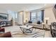 Spacious living room with hardwood floors, neutral color palette, and ample natural light at 6621 N Ceylon St, Denver, CO 80249